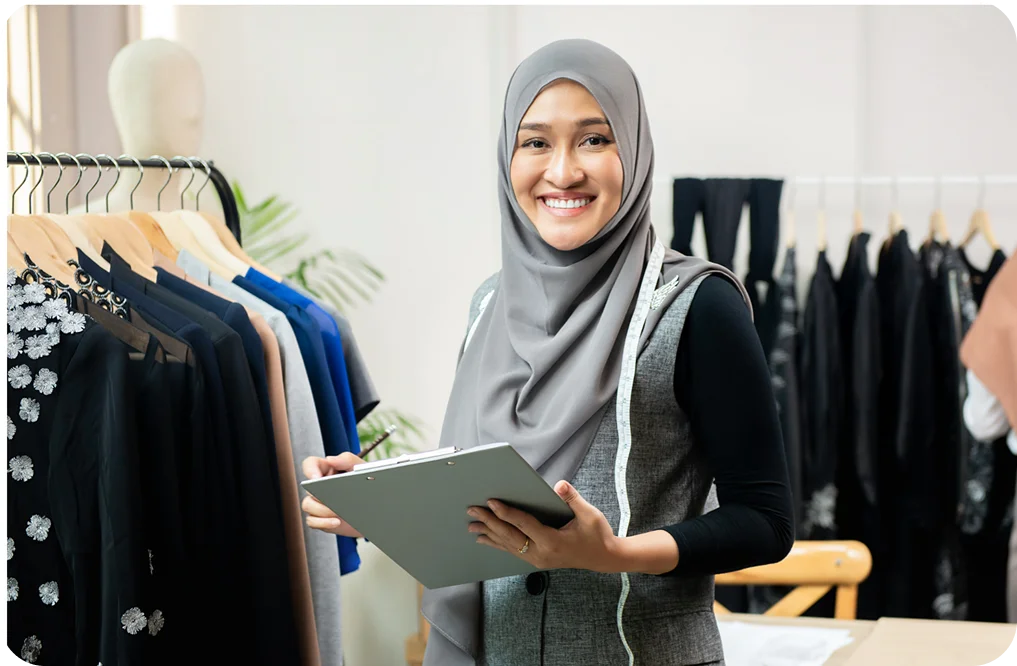 Muslim woman using POS system in a clothing store